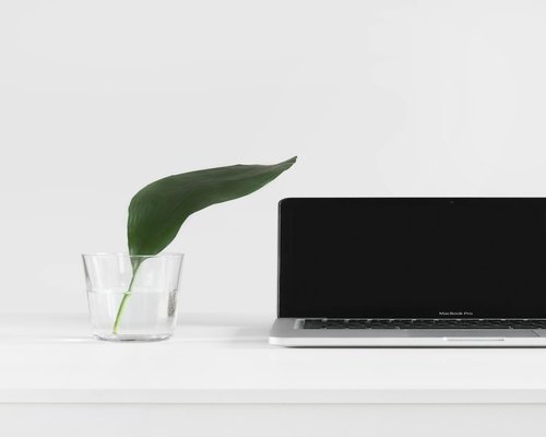 Desk setup with laptop and a fresh glass of water